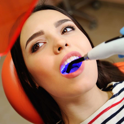 beautiful girl at the dentist trying the dental fillings service